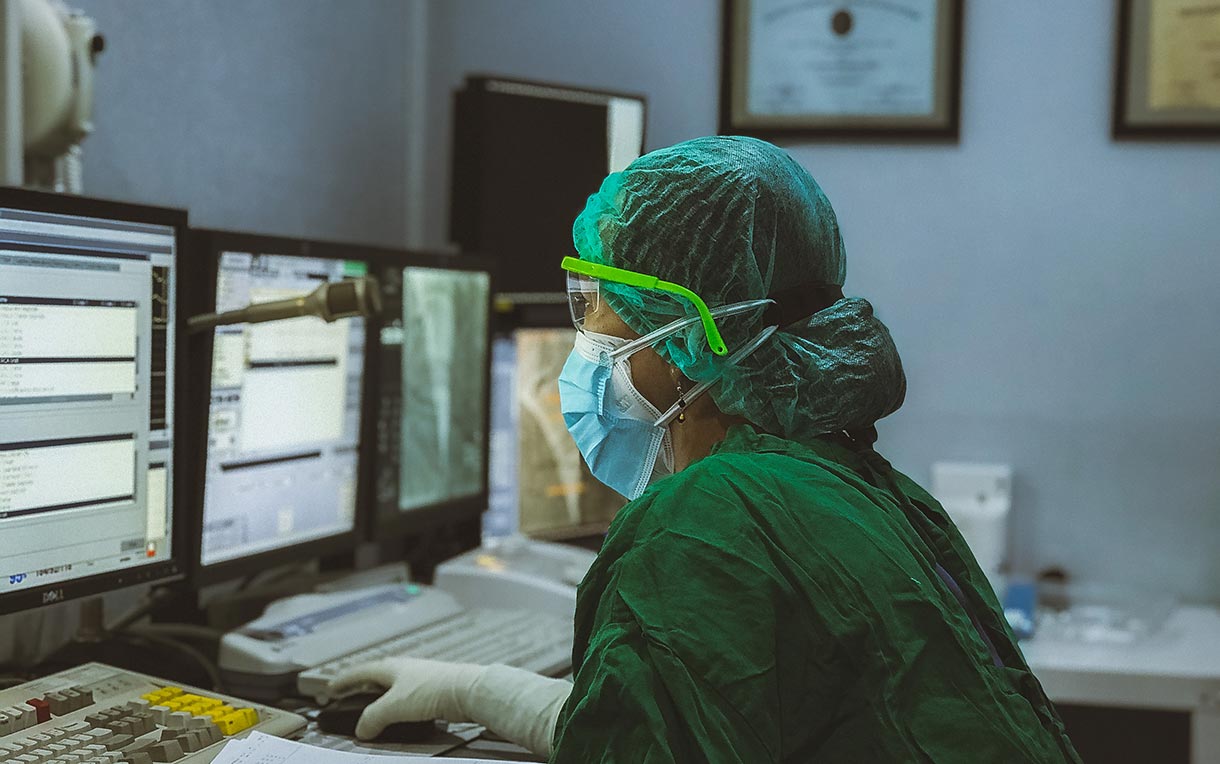 A nurse working in a control room.