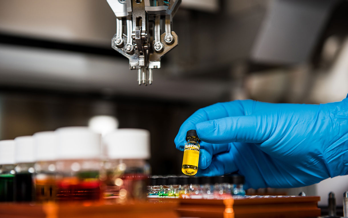 Laboratory researcher using a robot to prepare a variety of samples.