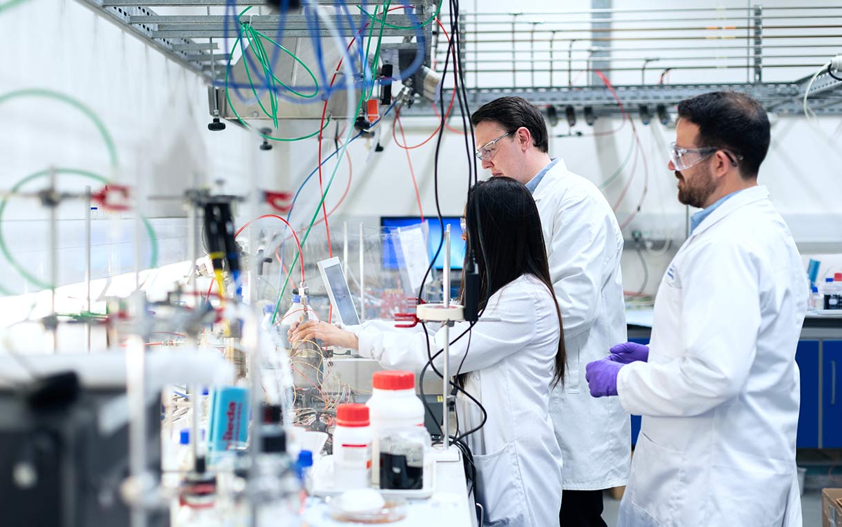 Three technicians working in the laboratory.